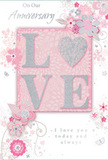 This elegant anniversary card, evocative of a romantic stroll through Morden's leafy streets, is built around a beautifully crafted LOVE motif at its centre. Each letter is gently raised from the card, edged with fine, glittering detail that sparkles softly like dew on early-morning petals. The colour story is soothing and romantic, anchored by blush pinks, creamy whites, and pale greys, with delicate touches of silver that add a refined, celebratory gleam. Surrounding the main word, a ring of illustrated flowers, leaves, and graceful swirls spreads in a loose, circular flow, reminiscent of a hand-tied bouquet laid flat on a florist's workbench. The blossoms are rendered with thin, elegant lines and gentle shading, giving them a light, almost ethereal quality, as though they were gently drifting across the surface of the card. The background holds everything in a soft pink haze, calming and warm, much like the atmosphere in a cosy Morden café where anniversary couples linger over coffee. Scattered among the florals, subtle flourishes and fine curls lend movement and depth, guiding the eye around the design without feeling busy. The accompanying anniversary message appears in a refined script, its curves and loops harmonising with the floral line work, expressing a quiet promise of ongoing love and companionship. The card's texture invites touch: smooth card stock contrasted with the glimmering, slightly grainy feel of the raised LOVE, echoing the contrast between satin gift ribbon and velvety petals. Thoughtfully composed, the design conveys enduring romance and tender celebration with the same care a local florist invests in every anniversary arrangement delivered across Morden.